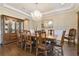 Formal dining room with wooden table, chandelier, and large display cabinet at 2604 S Bryant Cir, Tampa, FL 33629