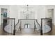 Grand foyer with a decorative chandelier, high ceilings, and a curved staircase at 2604 S Bryant Cir, Tampa, FL 33629