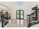 Grand foyer with marble floors, a soaring ceiling, and black framed glass entry doors at 2604 S Bryant Cir, Tampa, FL 33629