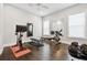 Spacious home gym featuring modern exercise equipment and hardwood flooring at 2604 S Bryant Cir, Tampa, FL 33629