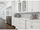 Modern kitchen with stainless steel appliances, custom white cabinetry, and a stylish backsplash at 2604 S Bryant Cir, Tampa, FL 33629