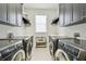 Well-organized laundry room with dual washer and dryer units and ample storage space for efficient chores at 2604 S Bryant Cir, Tampa, FL 33629