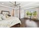 Serene main bedroom with tray ceilings, hardwood floors, and a large window creates a relaxing retreat at 2604 S Bryant Cir, Tampa, FL 33629
