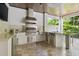 Well-equipped outdoor kitchen with stainless steel appliances and bar seating at 2604 S Bryant Cir, Tampa, FL 33629