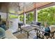 Inviting covered outdoor living space with ceiling fan, comfortable seating, and built-in outdoor kitchen at 2604 S Bryant Cir, Tampa, FL 33629
