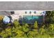 Aerial view of backyard pool with stone patio, lounge chairs, and lush landscaping at 2604 S Bryant Cir, Tampa, FL 33629