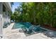 Inviting pool area featuring lounge chairs, steps into the water, and lush landscaping at 2604 S Bryant Cir, Tampa, FL 33629