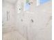 Modern shower featuring marble walls, multiple shower heads, and a built-in bench for a spa-like experience at 2604 S Bryant Cir, Tampa, FL 33629