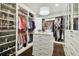 Large walk-in closet with custom shelving, storage for shoes and clothing, and a chandelier at 2604 S Bryant Cir, Tampa, FL 33629
