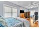 Bedroom features hardwood floors, a ceiling fan, and windows with bright natural light at 2638 Burlington N Ave, St Petersburg, FL 33713