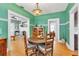 Dining room with green walls, hardwood floors, and a decorative Tiffany-style chandelier at 2638 Burlington N Ave, St Petersburg, FL 33713