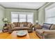 Comfortable living room with plush seating, hardwood floors, and large windows at 2638 Burlington N Ave, St Petersburg, FL 33713
