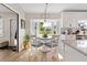 Charming dining area next to the kitchen features a round table, four chairs, and a bay window with a backyard view at 3074 Dothan Ave, Spring Hill, FL 34609