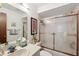 Cozy bathroom with white sink vanity and a tub-shower combo with glass sliding doors at 3093 Woodpine Cir, Sarasota, FL 34231