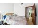 Bedroom featuring hardwood floors and a door leading to other rooms at 3093 Woodpine Cir, Sarasota, FL 34231