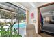 Relaxing bedroom view to the screened-in pool and lanai area at 3093 Woodpine Cir, Sarasota, FL 34231