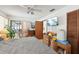 Bedroom features a ceiling fan and sliding glass doors to the lanai at 3093 Woodpine Cir, Sarasota, FL 34231