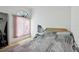Bedroom featuring a large window, woven headboard, and hardwood floors at 3093 Woodpine Cir, Sarasota, FL 34231