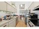 Well-lit kitchen with stainless steel appliances and modern cabinets, flowing into the living area at 3093 Woodpine Cir, Sarasota, FL 34231