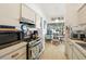 Kitchen with stainless steel oven, microwave, and hood with an adjacent breakfast nook at 3093 Woodpine Cir, Sarasota, FL 34231