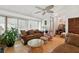 Living area with hardwood floors, large windows, and cozy seating, filled with natural light and a comfortable atmosphere at 3093 Woodpine Cir, Sarasota, FL 34231