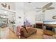Open-concept living space featuring hardwood floors, and a kitchen area in the background, creating a seamless flow at 3093 Woodpine Cir, Sarasota, FL 34231