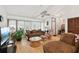 Comfortable living area with hardwood floors, large windows, and cozy seating arrangement filled with natural light at 3093 Woodpine Cir, Sarasota, FL 34231
