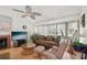 Cozy living room with hardwood floors, fireplace, large windows, and comfortable seating, perfect for relaxation at 3093 Woodpine Cir, Sarasota, FL 34231