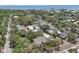 Bird's eye view of neighborhood featuring mature trees, streets, and a glimpse of the ocean at 316 5Th N Ave, Safety Harbor, FL 34695