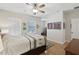 Bedroom features a ceiling fan, hardwood floors, and bright natural light at 316 5Th N Ave, Safety Harbor, FL 34695