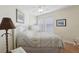 Inviting bedroom with a dresser, two windows, a comfortable bed, neutral walls, and hardwood floors at 316 5Th N Ave, Safety Harbor, FL 34695