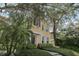 Attractive yellow two-story home featuring manicured landscaping and a welcoming facade at 316 5Th N Ave, Safety Harbor, FL 34695