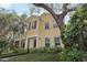 Inviting yellow two-story home with mature trees and meticulously maintained landscaping at 316 5Th N Ave, Safety Harbor, FL 34695