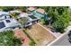 Aerial shot showcasing a home with solar panels and green exterior surrounded by mature landscape at 3251 34Th N Ave, St Petersburg, FL 33713