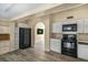 Kitchen features white cabinets, stainless appliances, and an arched doorway to the next room at 3251 34Th N Ave, St Petersburg, FL 33713