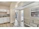 The kitchen area has a sink, backsplash, and built in shelving with a view to an outdoor area at 3251 34Th N Ave, St Petersburg, FL 33713