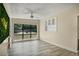 Bright living room with a large window, ceiling fan, and built-in shelving unit at 3251 34Th N Ave, St Petersburg, FL 33713