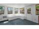 Bright sunroom with built-in bench seating, multiple windows, and white paneled walls at 3251 34Th N Ave, St Petersburg, FL 33713