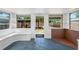 Open sunroom with built-in bench seating, multiple windows, and access to the backyard at 3251 34Th N Ave, St Petersburg, FL 33713