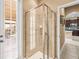 Modern bathroom featuring a tiled shower with a clear glass enclosure and a window for natural light at 32718 Summerglade Dr, Wesley Chapel, FL 33545