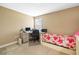 Cozy bedroom with a workspace featuring a desk, chair, and computer setup at 32718 Summerglade Dr, Wesley Chapel, FL 33545
