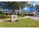 The Watergrass Club entrance sign surrounded by a lush green lawn, landscaping, and palm trees at 32718 Summerglade Dr, Wesley Chapel, FL 33545