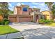 Attractive two-story home with a three-car garage, stone entrance, and well-manicured lawn and landscaping at 32718 Summerglade Dr, Wesley Chapel, FL 33545