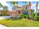 Beautiful two-story home with a three-car garage, stone entrance, and well-manicured landscaping at 32718 Summerglade Dr, Wesley Chapel, FL 33545