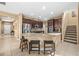 Open kitchen with stainless steel appliances, granite countertops, and a breakfast bar for casual dining at 32718 Summerglade Dr, Wesley Chapel, FL 33545