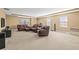 Large living room with neutral colored walls and carpet and comfortable leather furniture at 32718 Summerglade Dr, Wesley Chapel, FL 33545