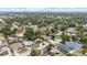Aerial view of neighborhood with lush greenery and single-Gathering homes with cityscape in background at 3605 W Paxton Ave, Tampa, FL 33611
