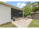 The backyard offers a brick patio perfect for seating and a screened lanai for enjoying the outdoors at 3605 W Paxton Ave, Tampa, FL 33611