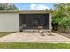 The backyard offers a brick patio perfect for seating and a screened lanai for enjoying the outdoors at 3605 W Paxton Ave, Tampa, FL 33611
