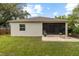 The home has a landscaped backyard with a screened lanai and brick patio seating area at 3605 W Paxton Ave, Tampa, FL 33611